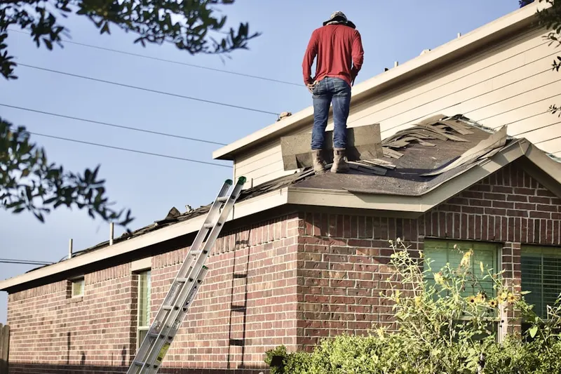 Professional roofer working on a residential roof in McNair